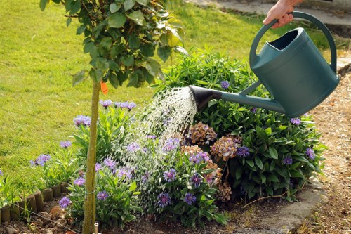 Instructor leading a training session for gardeners on safe machinery use